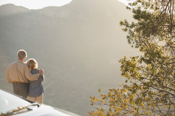 Naklejka premium Senior couple looking at mountain view outside car