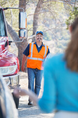 Roadside mechanic arriving to help woman