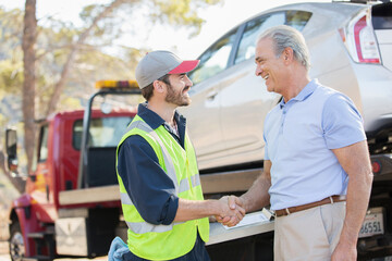 Roadside mechanic and man shaking hands