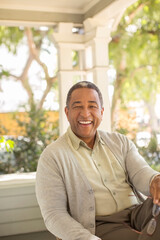 Fototapeta premium Portrait of laughing senior man on porch