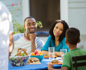 Family eating lunch at patio table