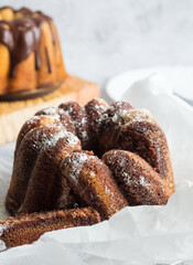 Delicious dessert, dark chocolate cake. On a wooden background