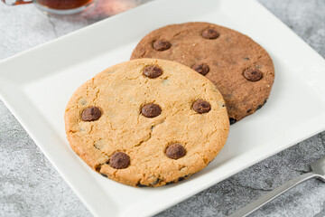 Chocolate chip cookies with tea on the stone table
