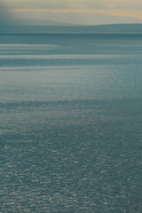 Fototapeta premium Morning sunlight beaming through clouds at Kvarner gulf of Adriatic sea in Croatia