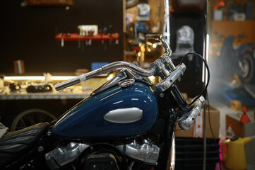 Polished, refurbished biker motorcycle in garage workshop