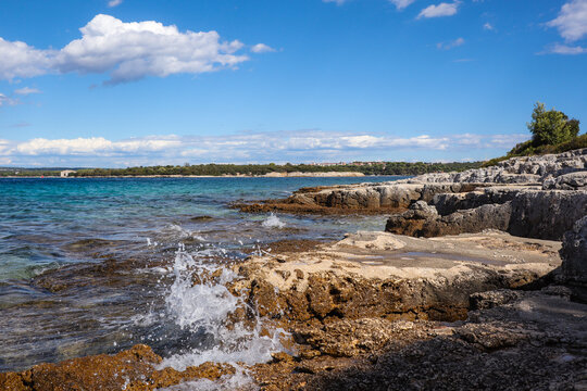 Summer Sunny Day in Sveti Jerolim Island with Rocky Shore. Adriatic Sea Splash in Brijuni National Park, Croatia.