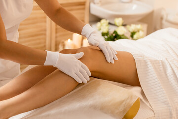 Fototapeta na wymiar Woman getting legs lymphatic drainage massage in spa salon 3