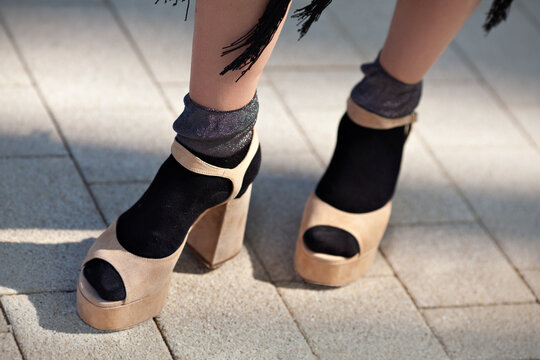 Close up Female legs in socks and open toed sandals on high heels. Stylish clothes and shoes. Trend fashion style