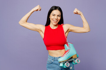 Young sporty latin woman she wear red casual clothes hold rollers show biceps muscles on hand demonstrating strength power isolated on plain pastel purple background. Summer lifestyle leisure concept. - obrazy, fototapety, plakaty