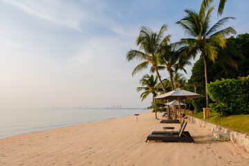 Beach of Bangsaray Pattaya Thailand at sunset with beach chairs and sunbeds