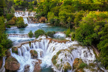 Krka, Croatia - Aerial view of the beautiful Krka Waterfalls in Krka National Park on a bright summer morning with green foliage and turquoise water