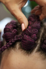 Braid the pigtails into a ponytail and an afro-tail