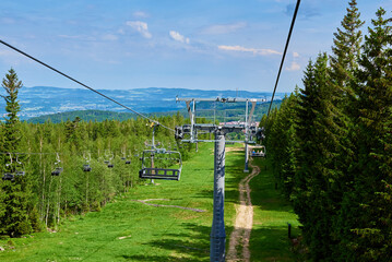 Ski lift in mountains. Karpacz resort in Poland with lift road. Mountain hiking and active vacation