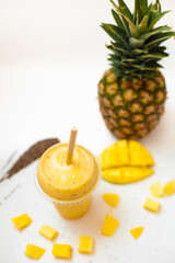 pineapple mango smoothie on a white background