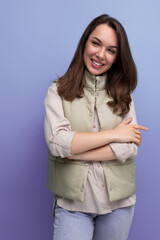 positive cheerful black-haired young lady in casual clothes over isolated background