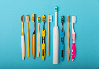 Electric and manual toothbrushes on a blue background. View from above. Oral hygiene. Ordinary...
