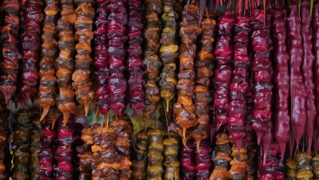 Close up of traditional Georgian cuisine candle shaped candy sweets Churchkhela with hazelnuts, walnuts, grape juice, honey in local market