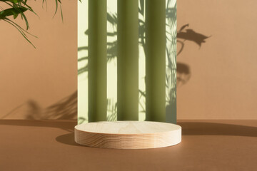 Wooden podium on an abstract green and beige background with a shadow of palm leaves. A scene with a geometric backdrop. Empty showcase, display case for the product presentation.