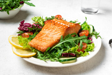 Grilled salmon fish fillet and green salad