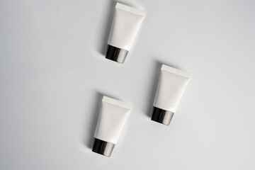 Plastic white tube for cream or lotion. Skin care or sunscreen cosmetic on white background 
