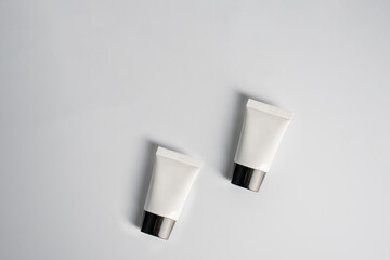 Plastic white tube for cream or lotion. Skin care or sunscreen cosmetic on white background 