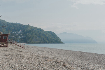 natural landscape of sea and green mountains, pebble beach, black sea Gonio village near Batumi, Georgia