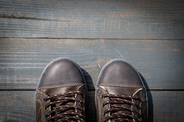 Concept of success and goals. Shoes on a wooden texture background