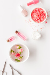 Hands and nails care set with manicure tools and roses flowers.