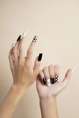 Woman hands with trendy manicure on brown background 