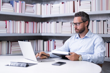 Portrait of serious business man in library. Handsome business man in office. Business man giving classes. Office business.