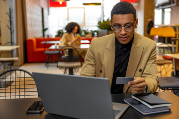 Young businessman working on laptop and looking involved