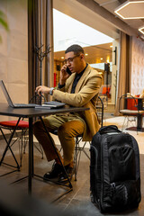 Young businessman having a call while waiting for a room in a hotel