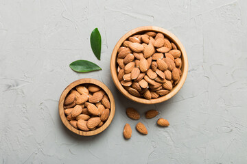 Fresh healthy Almond in bowl on colored table background. Top view