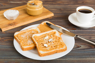 Peanut butter sandwiches or toasts on light table background.Breakfast. Vegetarian food. American cuisine top view vith copy space