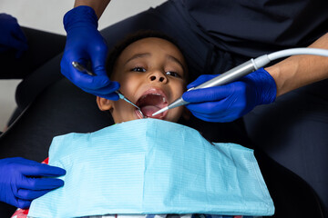 Dark-skinned boy having session in dentistry