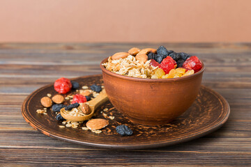 Cooking a wholesome breakfast. Granola with Various dried fruits and nuts in a bowl. The concept of a healthy dessert. Flat lay, top view with copy space