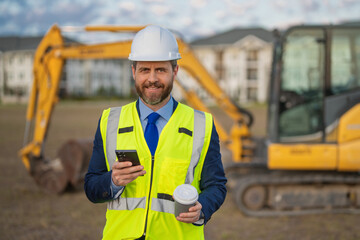 Supervisor in suit and helmet. Investor civil engineer, construction manager at a construction. Construction building developer at a construction site. Successful architect. Handsome builder man in