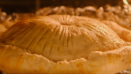 Cooking process of puff pastry meat pie inside home kitchen oven