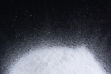 Pile of glucose or grape sugar on a black background.