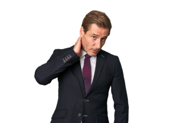 A middle-aged businessman isolated touching back of head, thinking and making a choice.