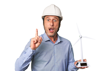 A middle-aged architect man holding a windmill model having an idea, inspiration concept.