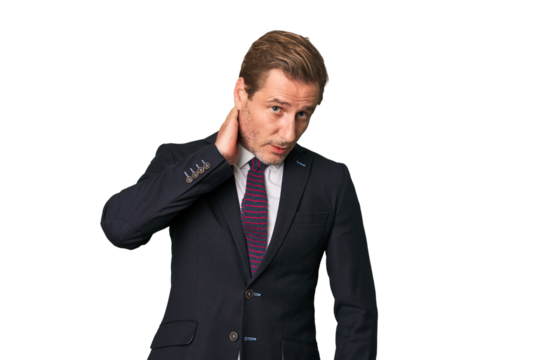 A middle-aged businessman isolated touching back of head, thinking and making a choice.