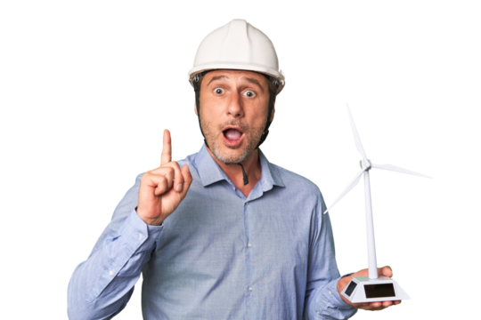 A middle-aged architect man holding a windmill model having an idea, inspiration concept.