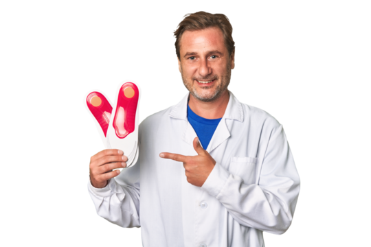 A middle-aged podiatrist holding an insoles