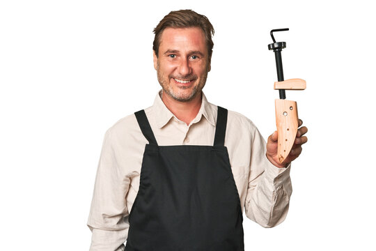 A middle-aged shoemaker holding a shoe last - Powered by Adobe