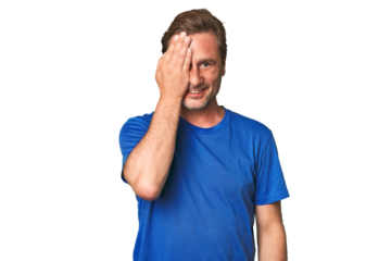 A middle-aged man isolated having fun covering half of face with palm.