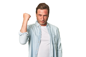 A middle-aged man isolated showing fist to camera, aggressive facial expression.