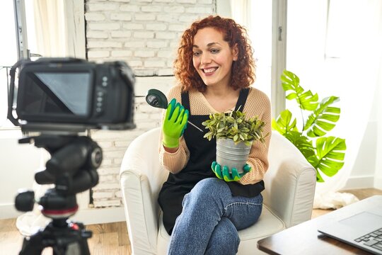 Redhead gardening influencer preps video, sharing plant facts with moisture meter.