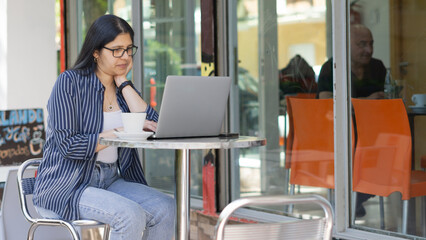 young hardworking woman enjoying a coffee on an autumn afternoon