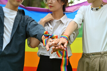 Group of young people stacking hands together, showing freedom and unity, shooting of equality social